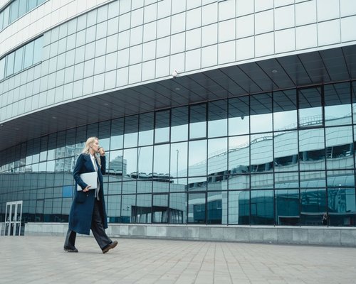 Active professional walking towards an office building in a Polish city